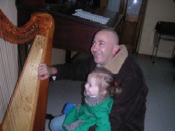 father and daughter examine harp